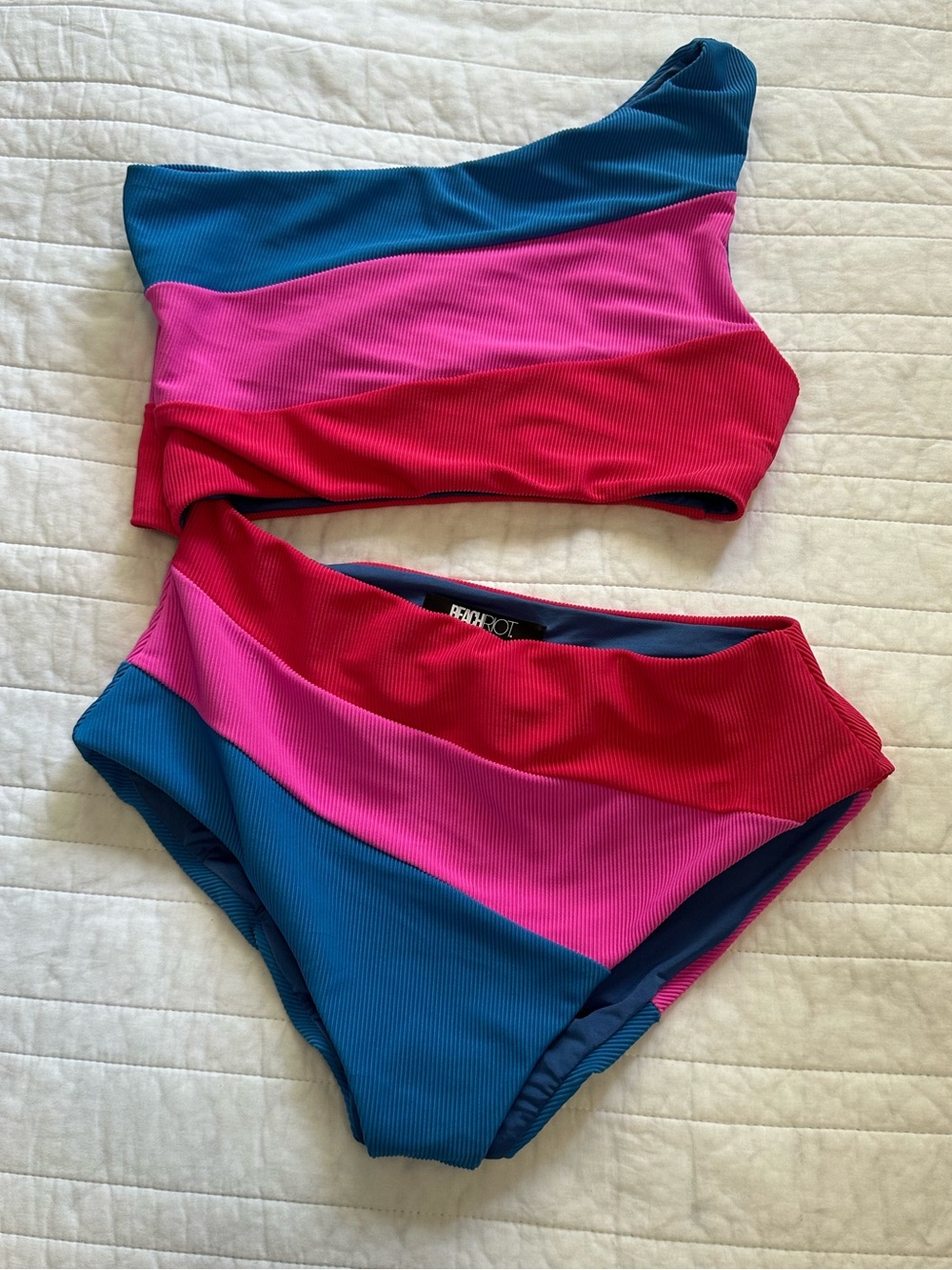 Beach Riot blue swimsuit lining with pink trim